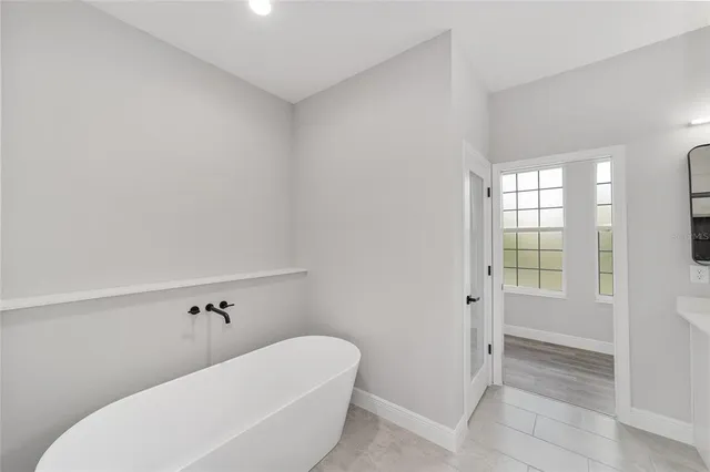 a bathroom with a toilet and bathtub