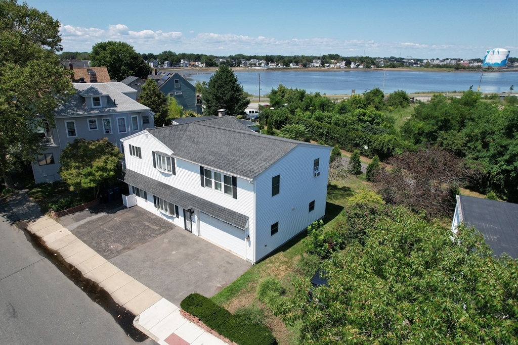 a view of a house with a yard and lake view