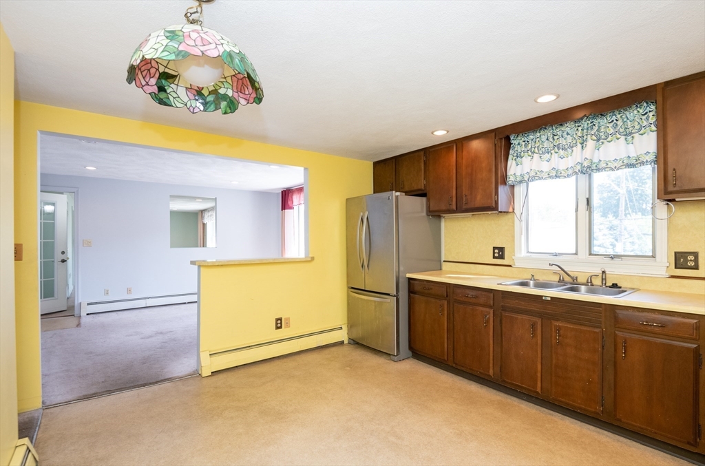24 Webb Street Salem, MA 01970 - Photo 14 of 38 a kitchen with a refrigerator and a sink