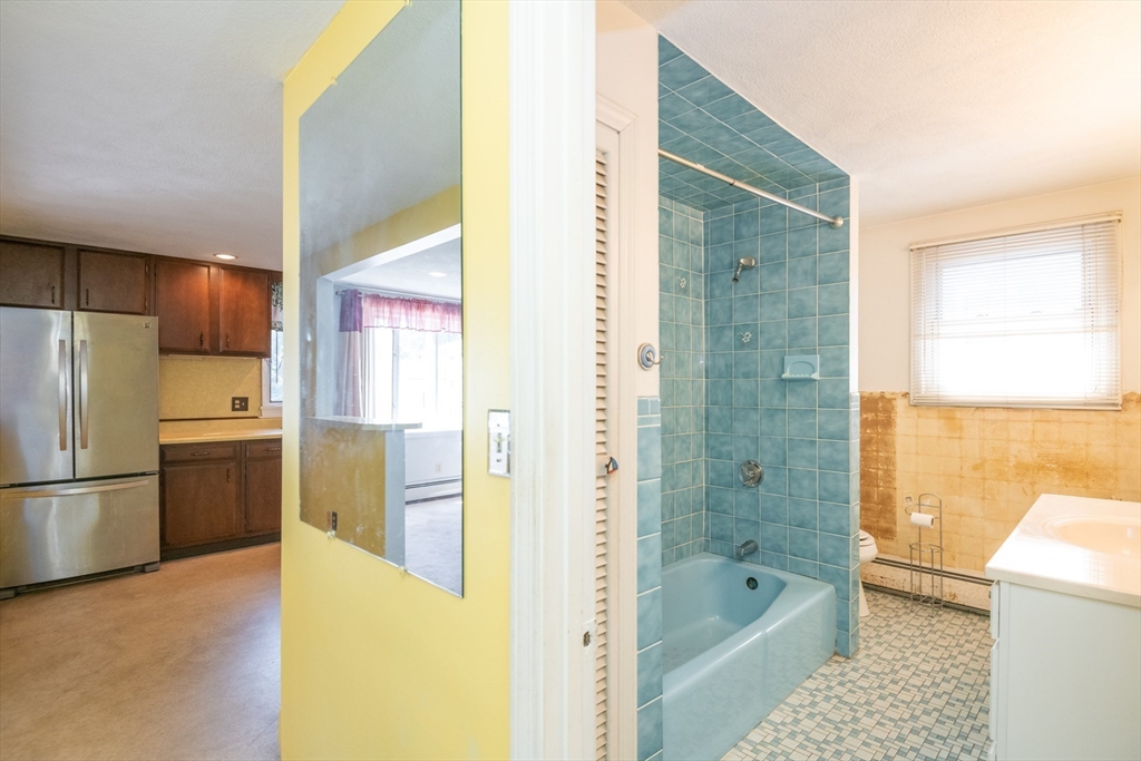 24 Webb Street Salem, MA 01970 - Photo 15 of 38 a bathroom with a tub shower and a sink