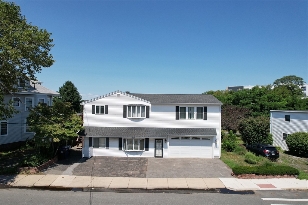24 Webb Street Salem, MA 01970 - Photo 2 of 38 a view of a big house with a big yard and large tree