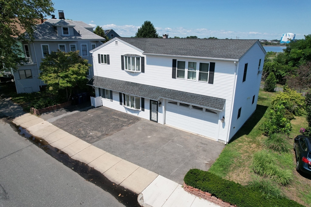 24 Webb Street Salem, MA 01970 - Photo 3 of 38 a view of house with a yard and potted plants