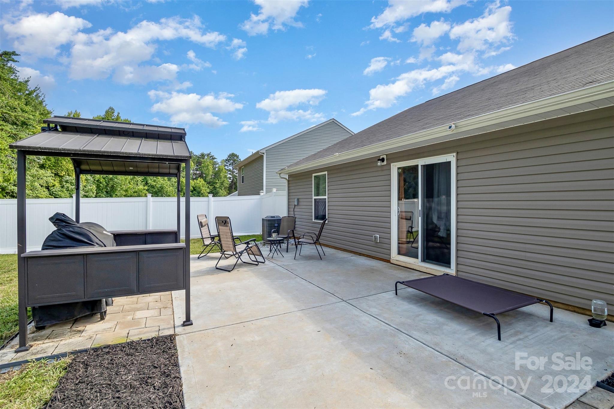 1075 Winding Creek Road Salisbury, NC 28146 - Photo 4 of 18 a backyard of a house with table and chairs