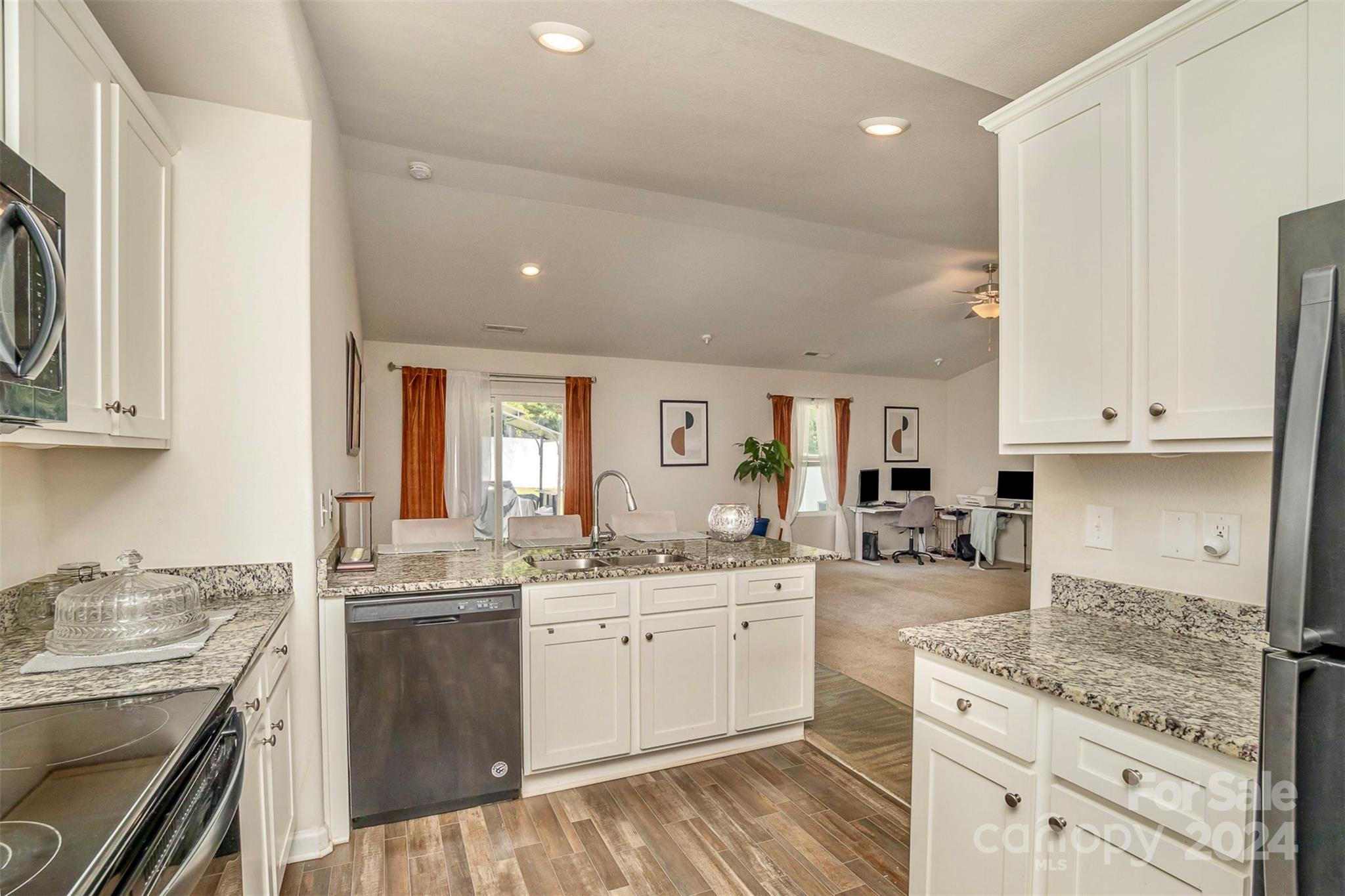1075 Winding Creek Road Salisbury, NC 28146 - Photo 9 of 18 a kitchen with a sink stove and cabinets