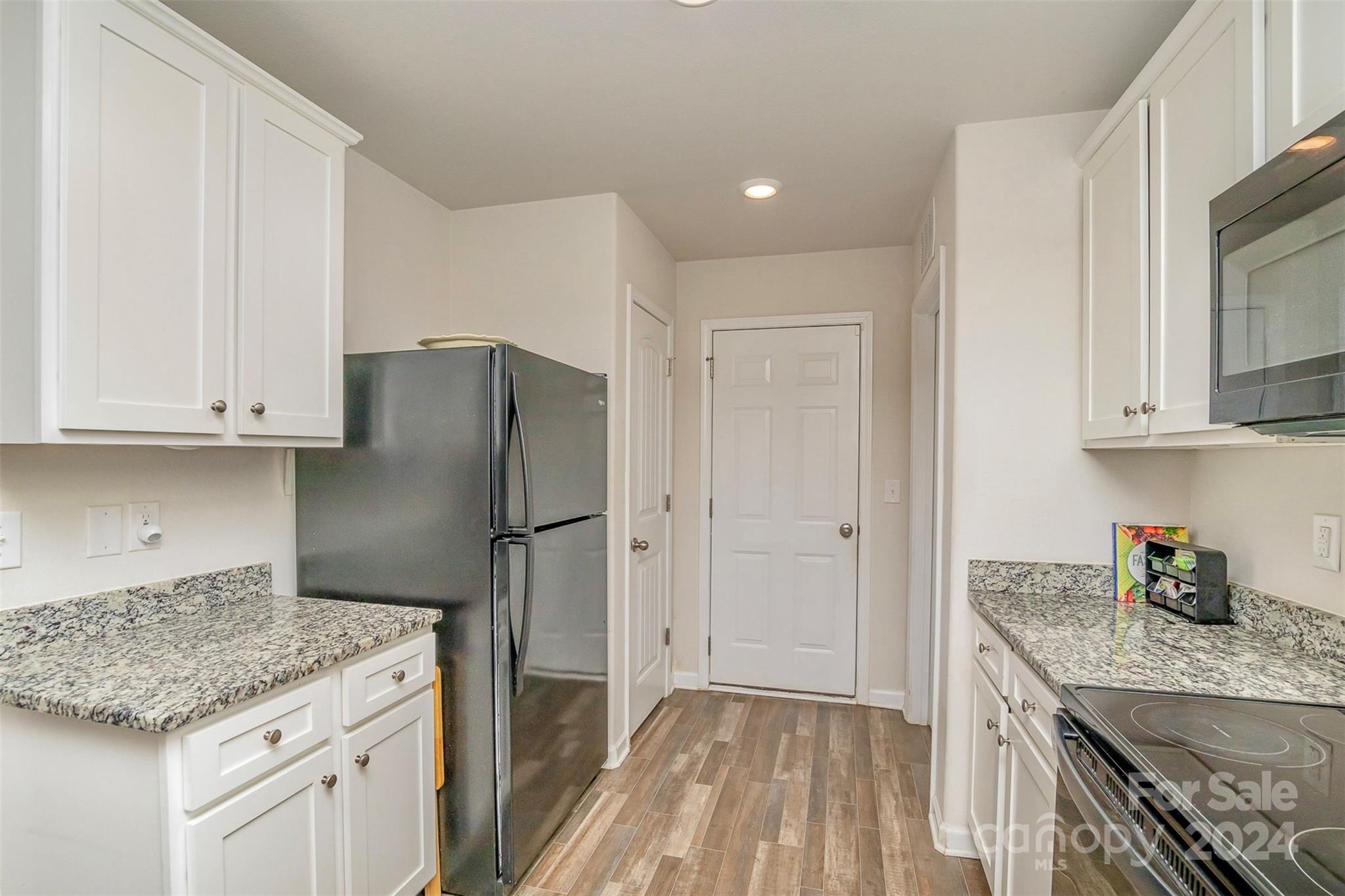 1075 Winding Creek Road Salisbury, NC 28146 - Photo 10 of 18 a kitchen with stainless steel appliances granite countertop a sink stove and refrigerator