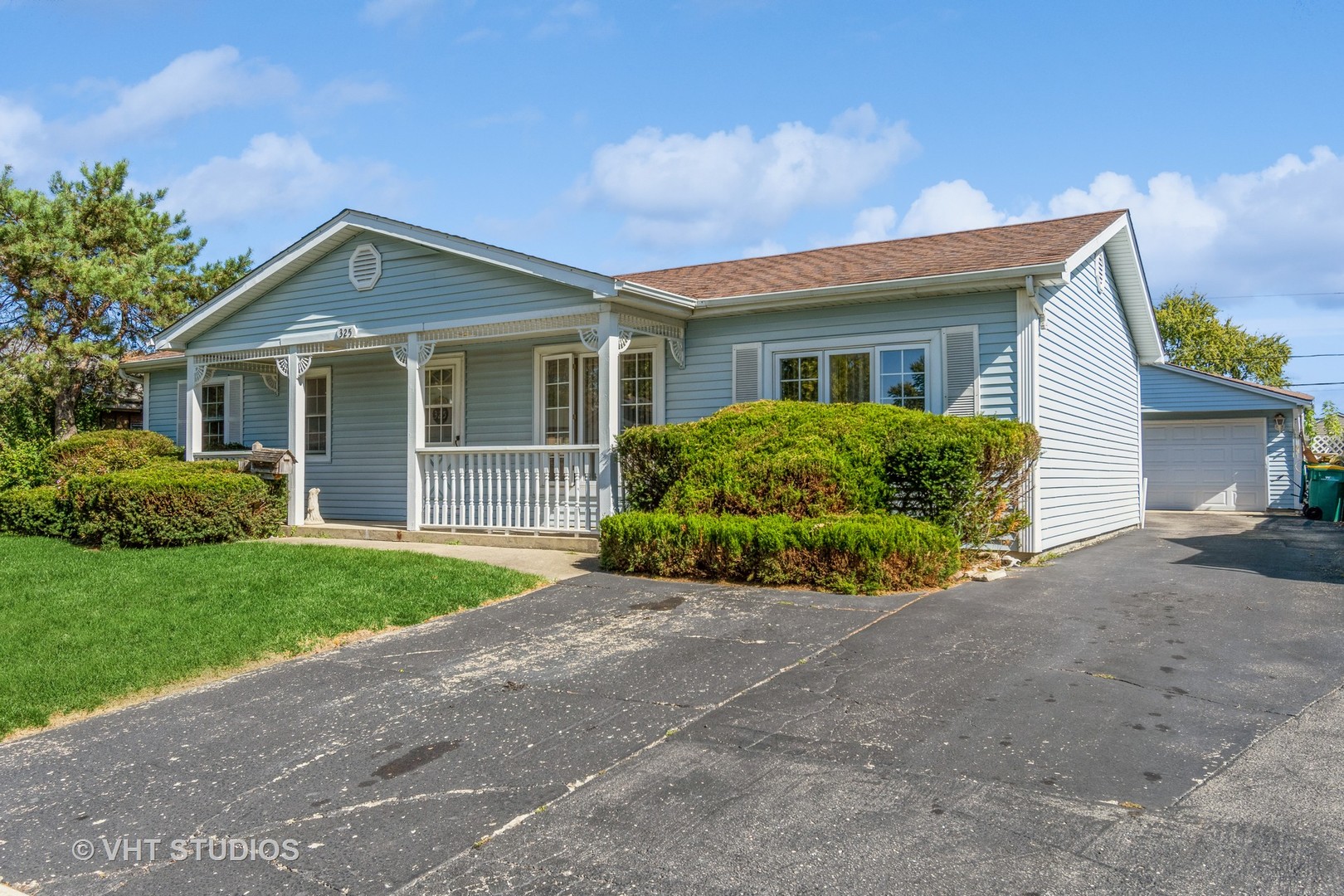 325 Kirman Avenue Romeoville, IL 60446 - Photo 1 of 13 a front view of a house with a garden and plants