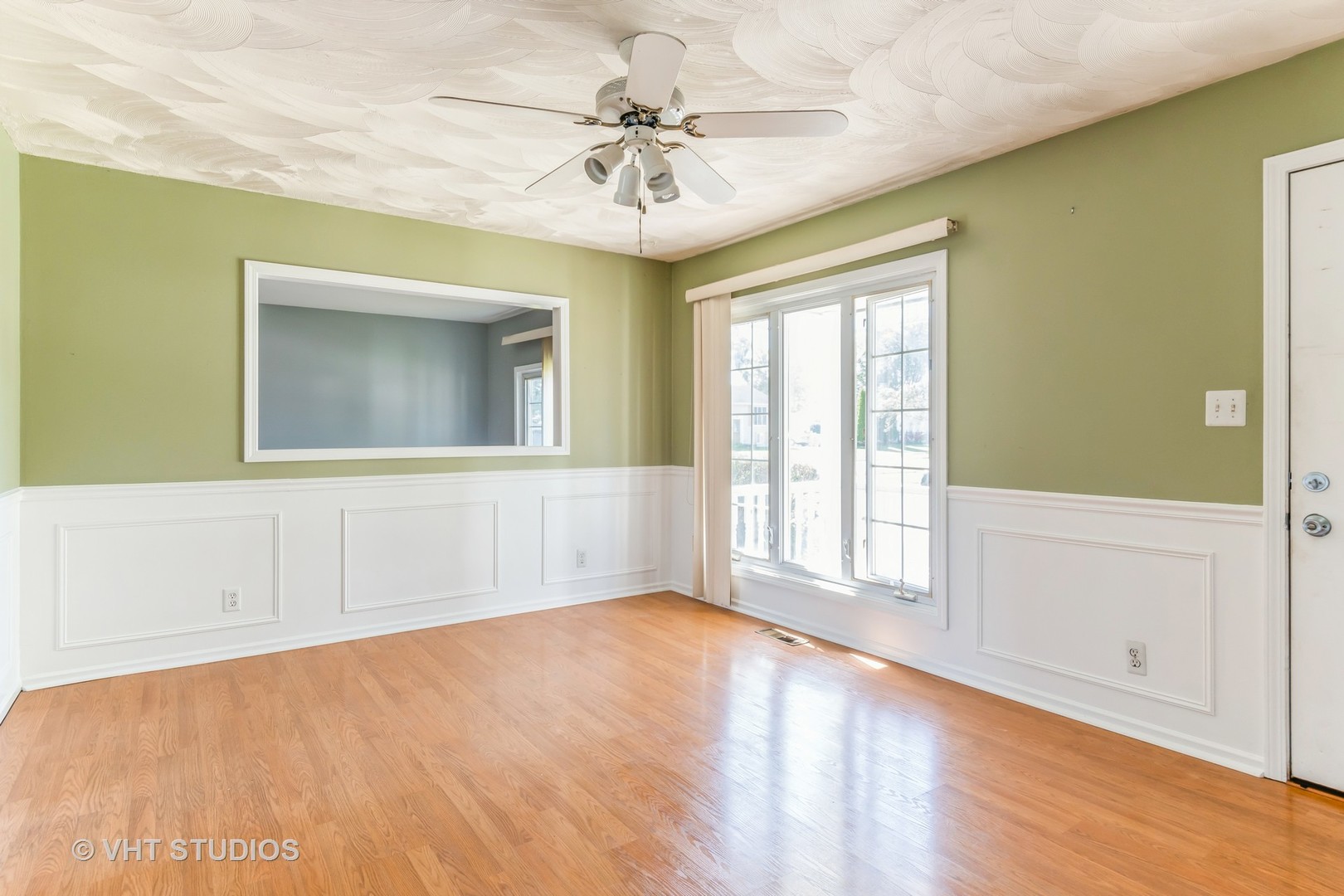 325 Kirman Avenue Romeoville, IL 60446 - Photo 3 of 13 a view of an empty room with a window and a chandelier fan