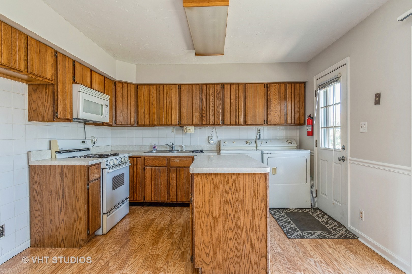 325 Kirman Avenue Romeoville, IL 60446 - Photo 4 of 13 a kitchen with stainless steel appliances granite countertop a sink stove and cabinets