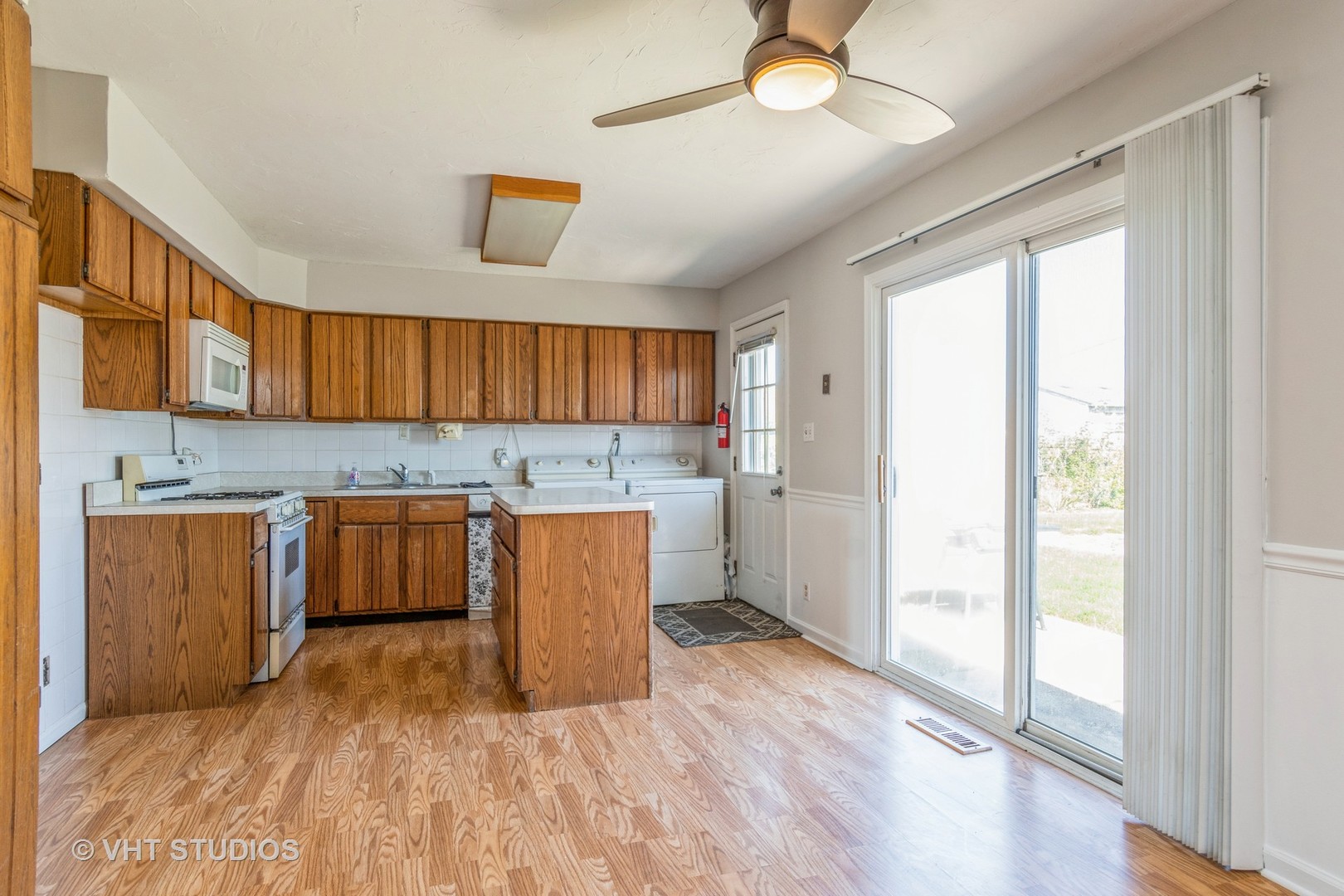 325 Kirman Avenue Romeoville, IL 60446 - Photo 5 of 13 a kitchen with wooden floors and wooden cabinets