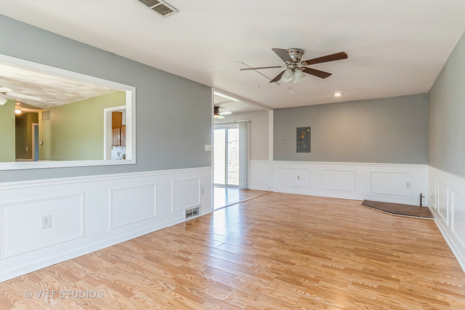325 Kirman Avenue Romeoville, IL 60446 - Photo 7 of 13 a view of an empty room with wooden floor and a window