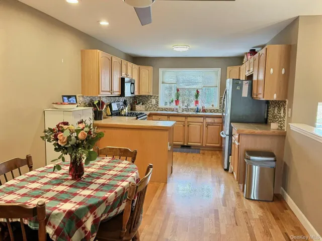 a view of a dining room with furniture a kitchen and chandelier
