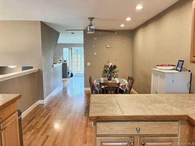 a kitchen with kitchen island a counter top space a sink stainless steel appliances and cabinets