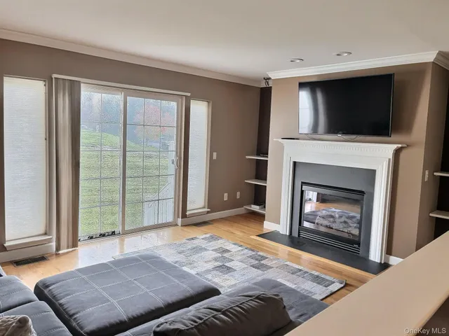 a living room with a fireplace and a flat screen tv