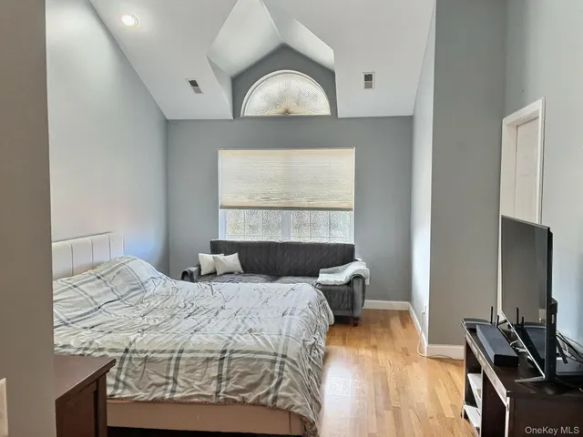 a bedroom with a bed and a window