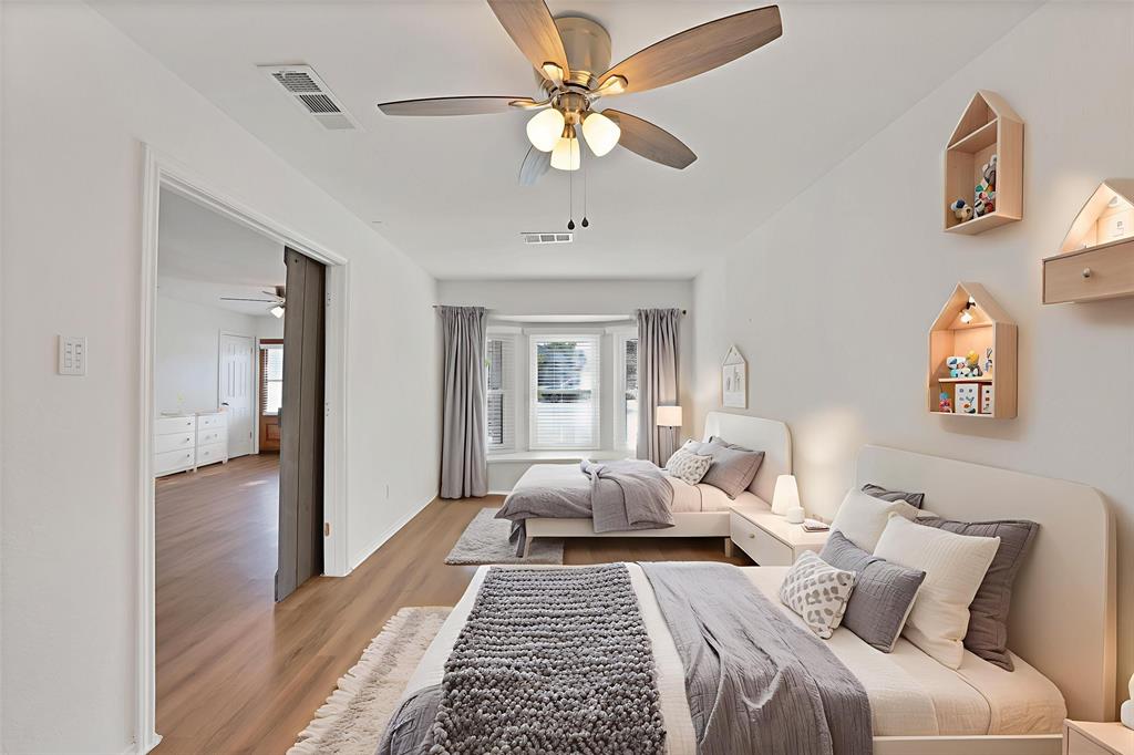 715 East Avenue F Midlothian, TX 76065 - Photo 12 of 33 a bedroom with a bed and wooden floor