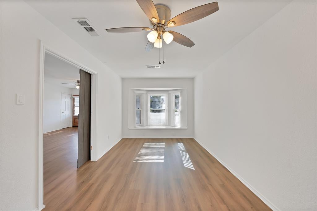 715 East Avenue F Midlothian, TX 76065 - Photo 13 of 33 wooden floor in an empty room with a window