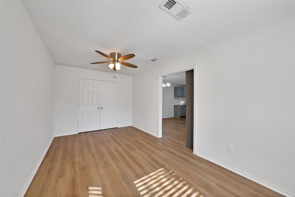715 East Avenue F Midlothian, TX 76065 - Photo 14 of 33 a view of a room with wooden floor and a ceiling fan
