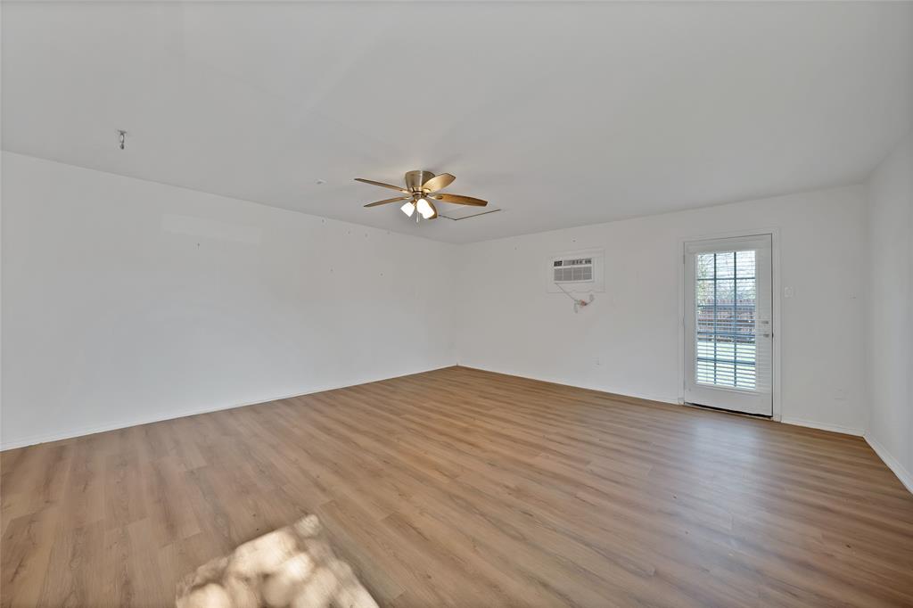 715 East Avenue F Midlothian, TX 76065 - Photo 17 of 33 a view of an empty room with wooden floor and a window