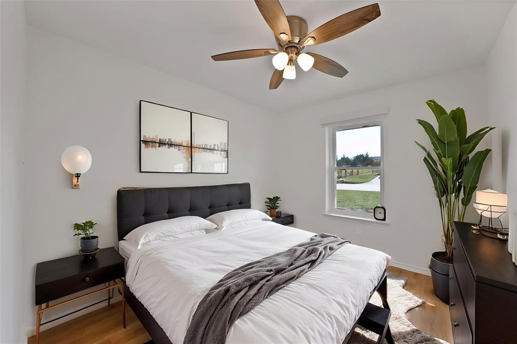 715 East Avenue F Midlothian, TX 76065 - Photo 19 of 33 a bedroom with a large bed and a chandelier