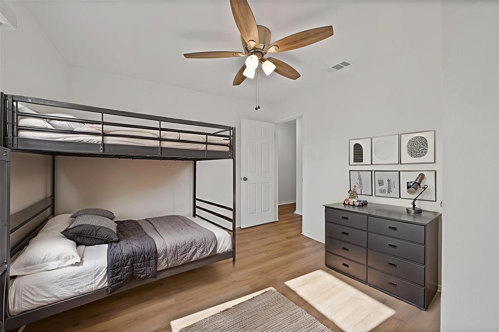 715 East Avenue F Midlothian, TX 76065 - Photo 22 of 33 a bedroom with a bed and a chandelier