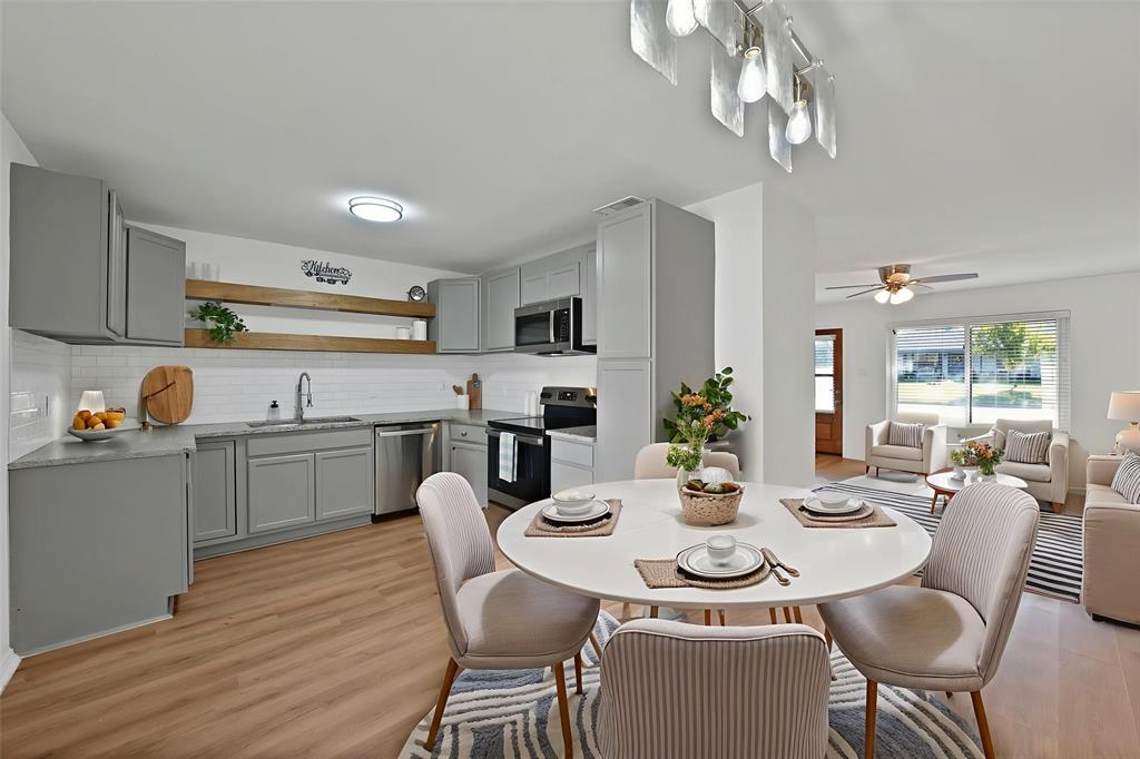 715 East Avenue F Midlothian, TX 76065 - Photo 5 of 33 a view of a dining room with furniture and wooden floor