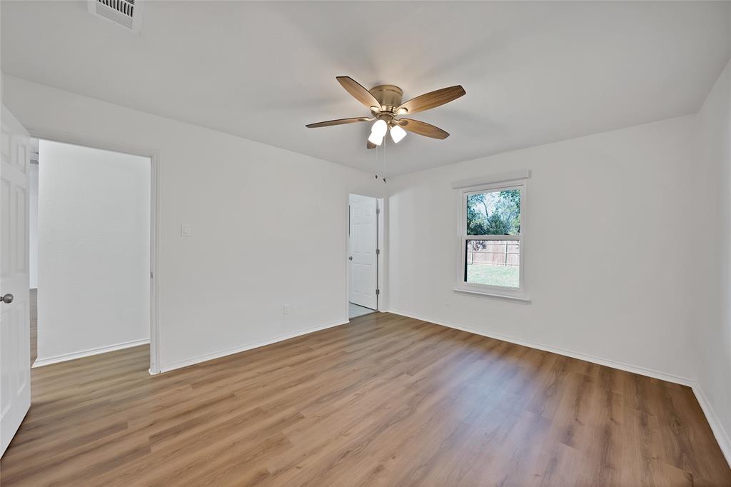 715 East Avenue F Midlothian, TX 76065 - Photo 9 of 33 a view of empty room with wooden floor and fan