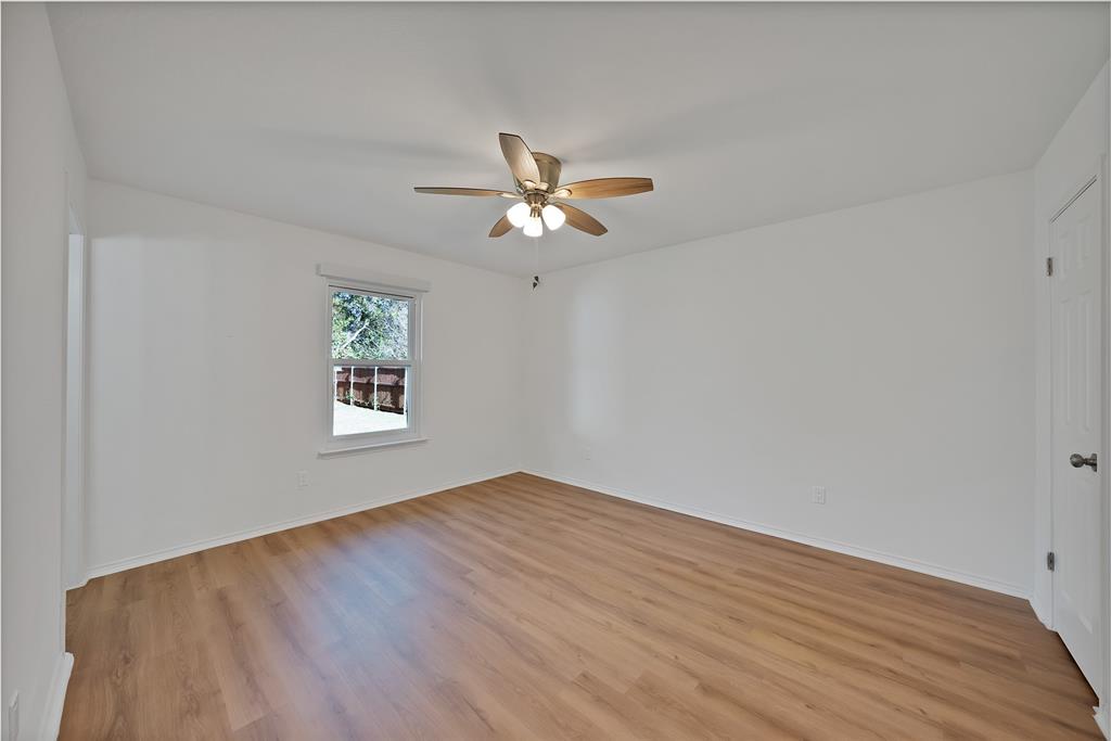715 East Avenue F Midlothian, TX 76065 - Photo 10 of 33 wooden floor in an empty room with a window