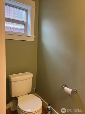 a white toilet sitting next to a window