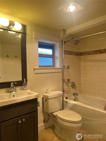 a bathroom with a sink toilet vanity and shower