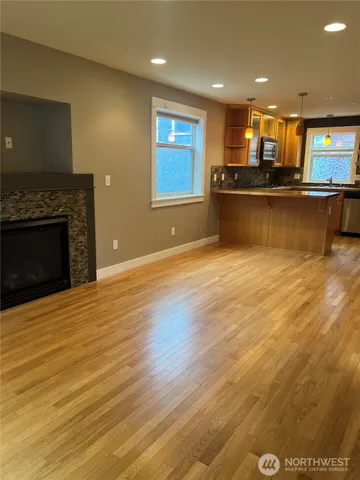 a view of kitchen with kitchen island microwave and stove