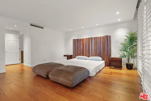 a bedroom with a large bed and a large window