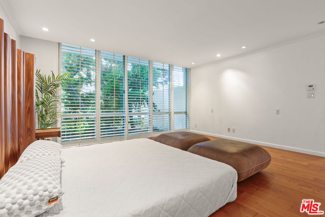 2170 Century Park East, Unit 104 Los Angeles, CA 90067 - Photo 16 of 42 a bedroom with a large bed and a large window