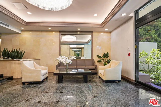 a living room with furniture and a chandelier