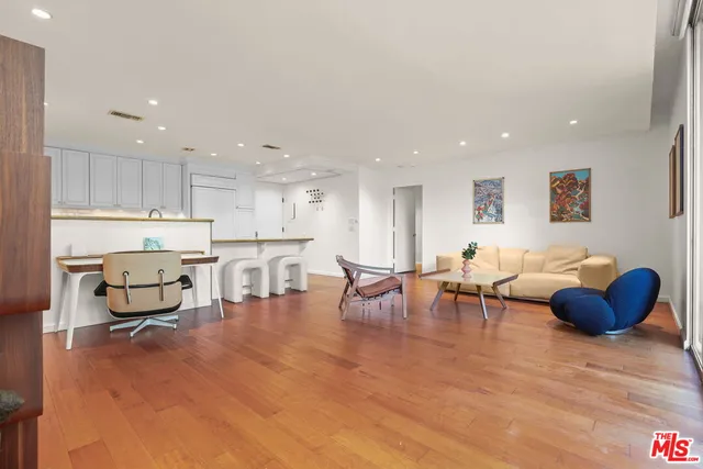 a kitchen with kitchen island a stove a table and chairs in it
