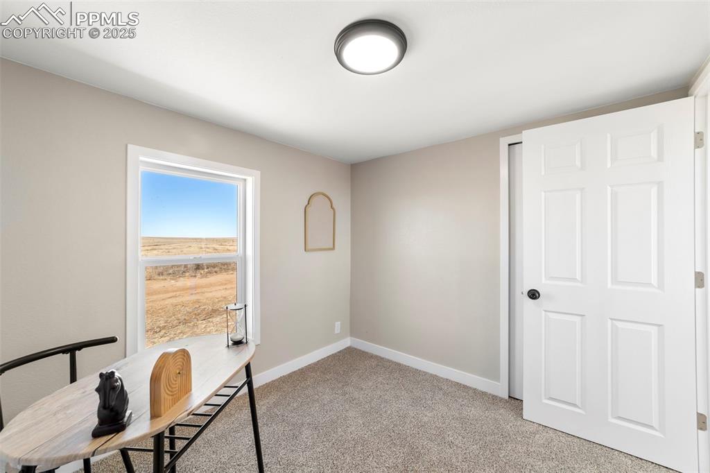 35275 Book Road Yoder, CO 80864 - Photo 18 of 30 a view of a workspace with furniture and a window