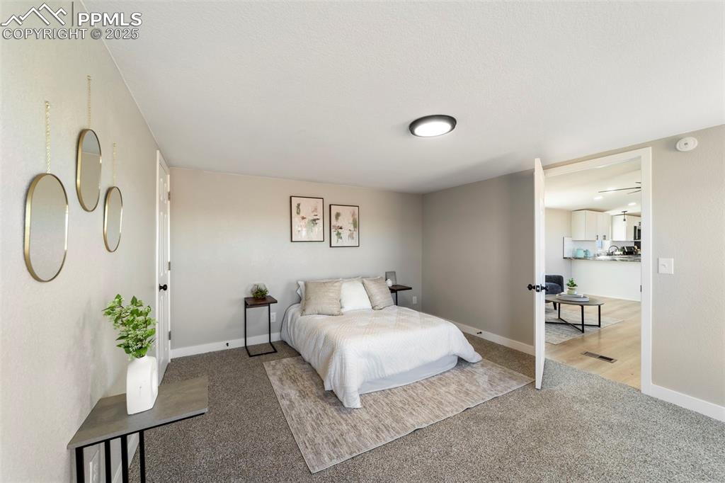 35275 Book Road Yoder, CO 80864 - Photo 21 of 30 a bedroom with a bed and a chandelier