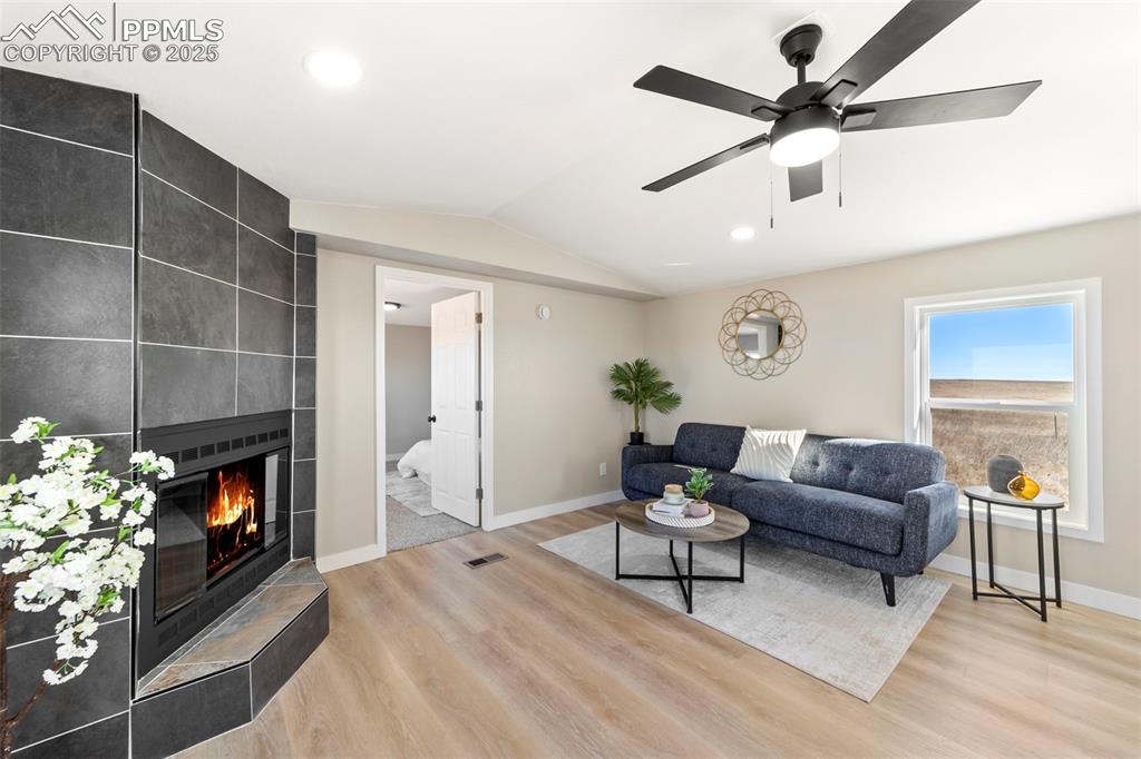 35275 Book Road Yoder, CO 80864 - Photo 4 of 30 a living room with furniture a flat screen tv and a fireplace