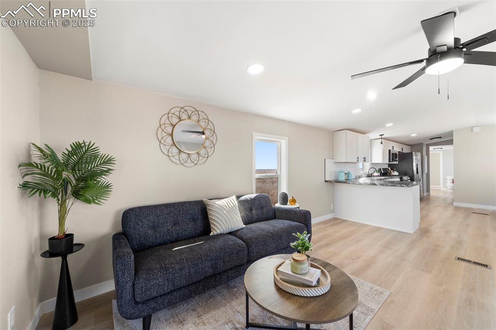 35275 Book Road Yoder, CO 80864 - Photo 6 of 30 a living room with furniture and a chandelier