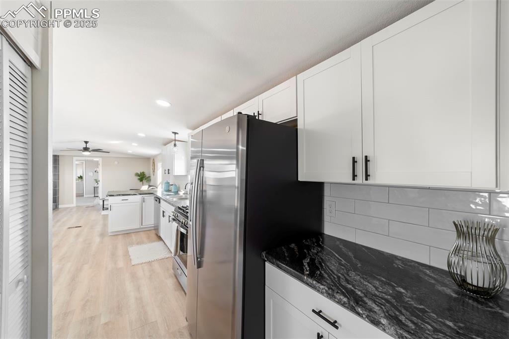 35275 Book Road Yoder, CO 80864 - Photo 9 of 30 a kitchen with a refrigerator and white cabinets