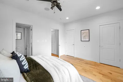 a bedroom with a large bed and a window