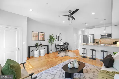 a living room with furniture and wooden floor