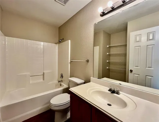 a bathroom with a sink toilet mirror and shower