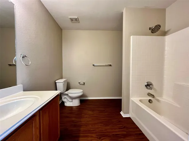 a bathroom with a sink a toilet and bathtub