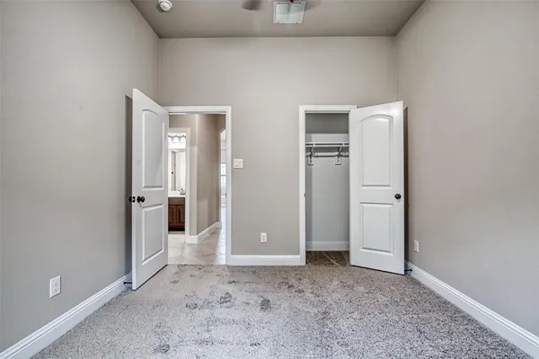 a view of a big room with chandelier fan and closet area
