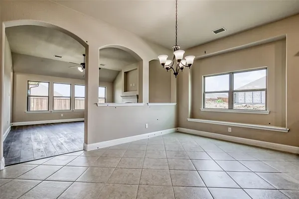 a view of a kitchen with a sink large windows a kitchen and microwave