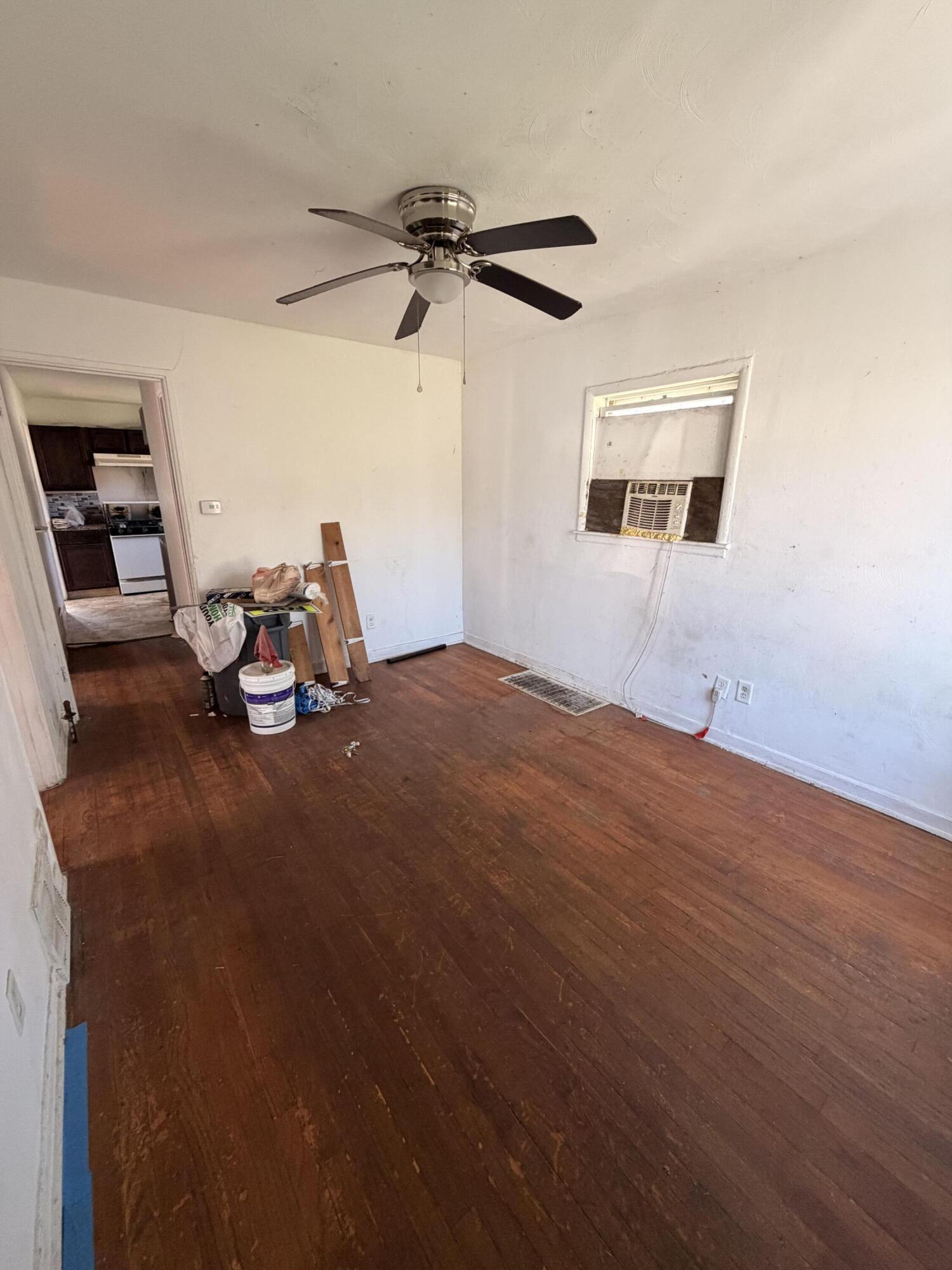 1724 Fillmore Street Gary, IN 46407 - Photo 2 of 8 a view of a room with wooden floor and ceiling fan