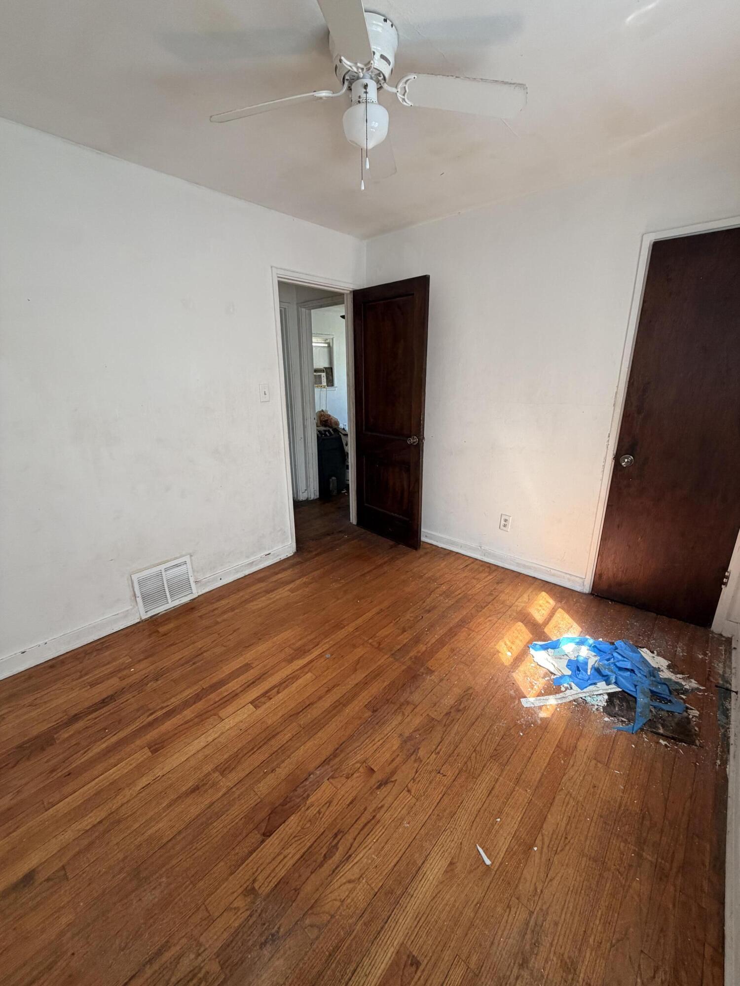 1724 Fillmore Street Gary, IN 46407 - Photo 4 of 8 wooden floor in an empty room with a window
