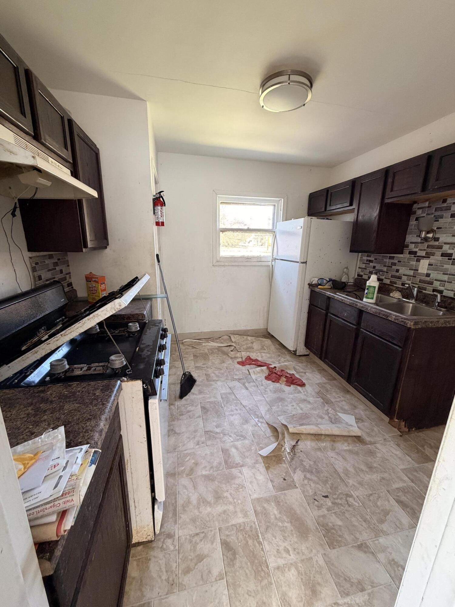 1724 Fillmore Street Gary, IN 46407 - Photo 6 of 8 a kitchen with a stove and a refrigerator