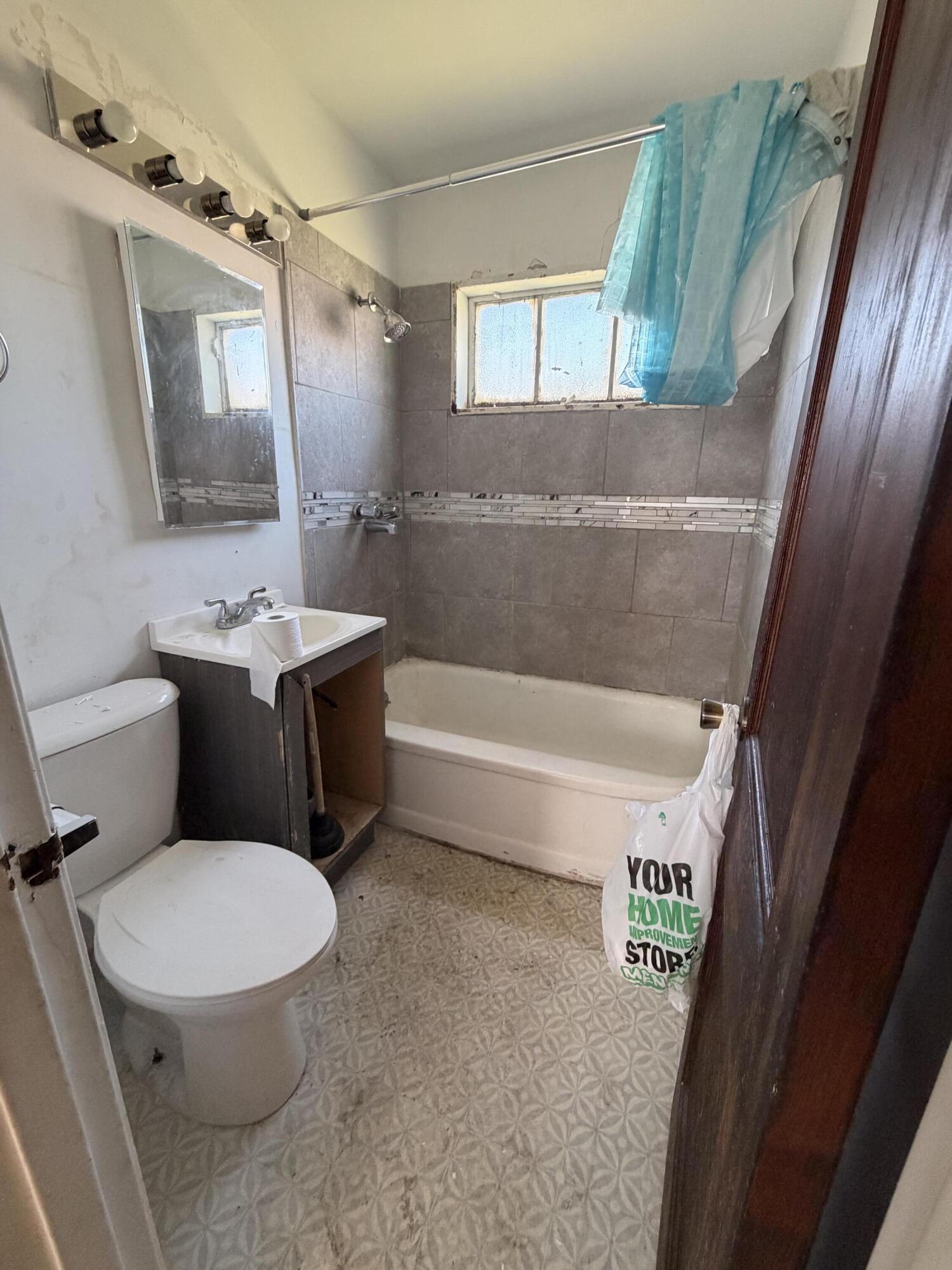 1724 Fillmore Street Gary, IN 46407 - Photo 7 of 8 a bathroom with a toilet a sink and a bathtub