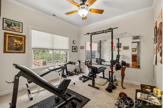 a room with gym equipment and windows